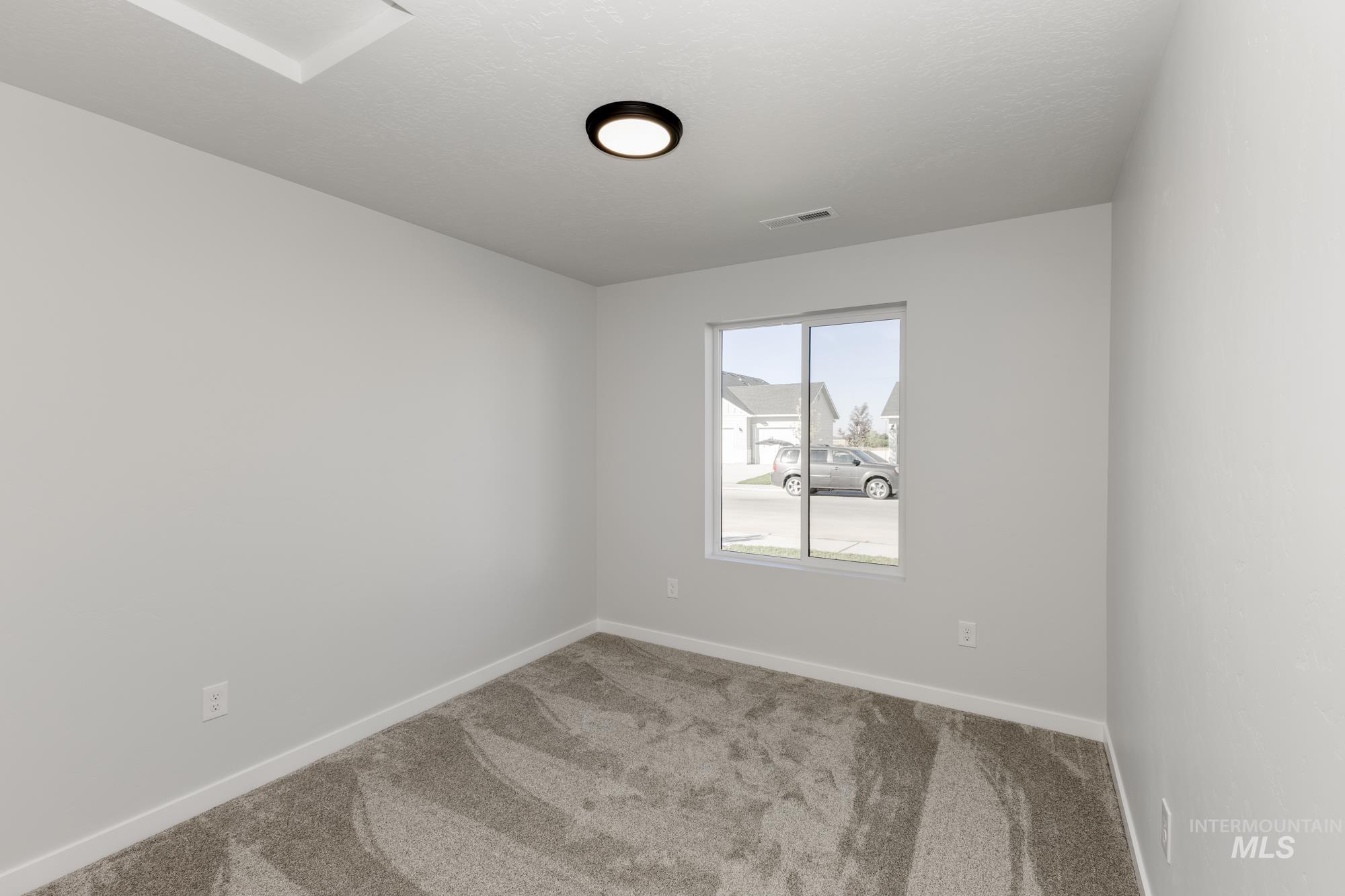 Unfurnished room with carpet floors and baseboards