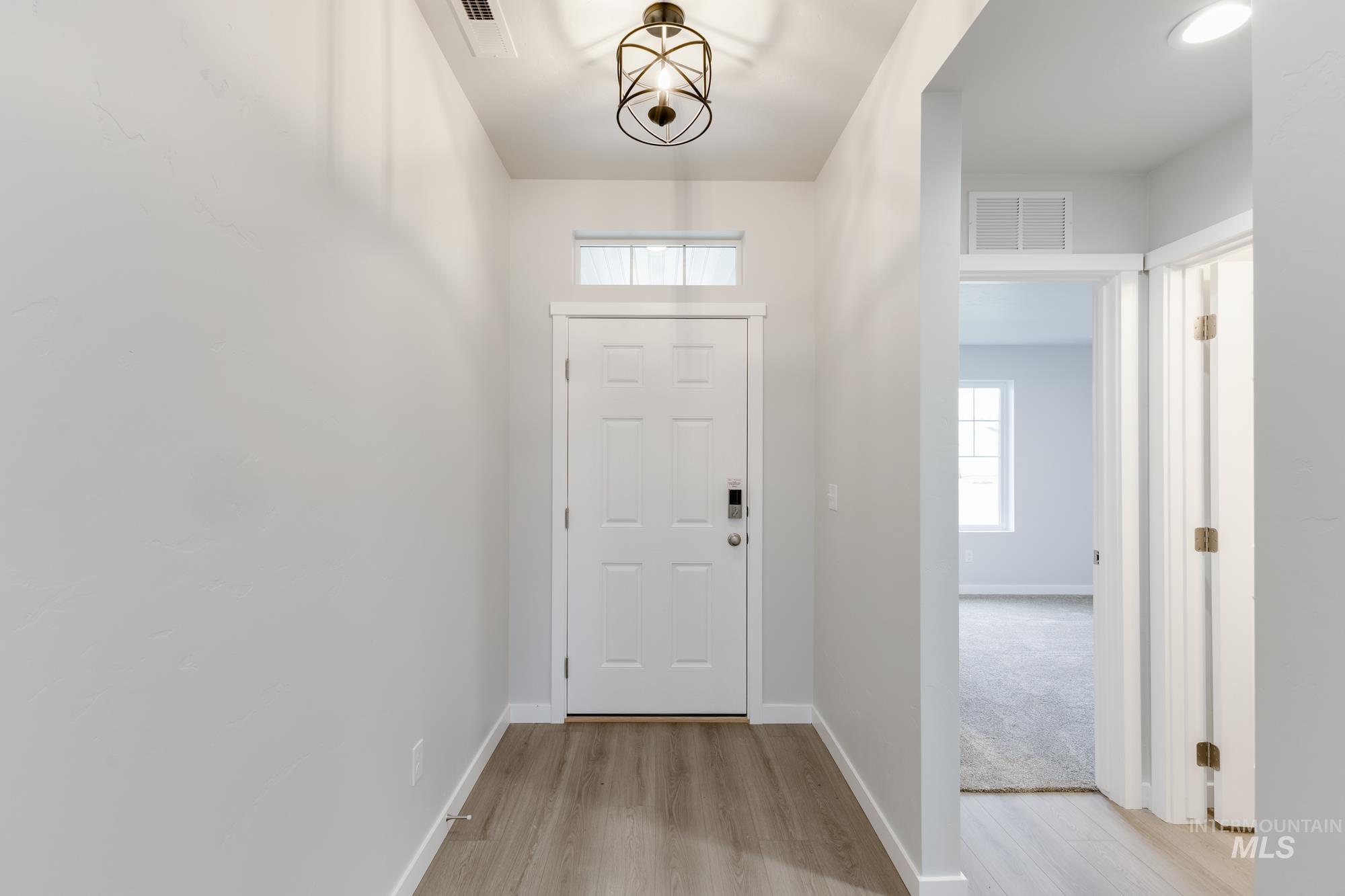 Foyer entrance featuring baseboards and light wood-type flooring