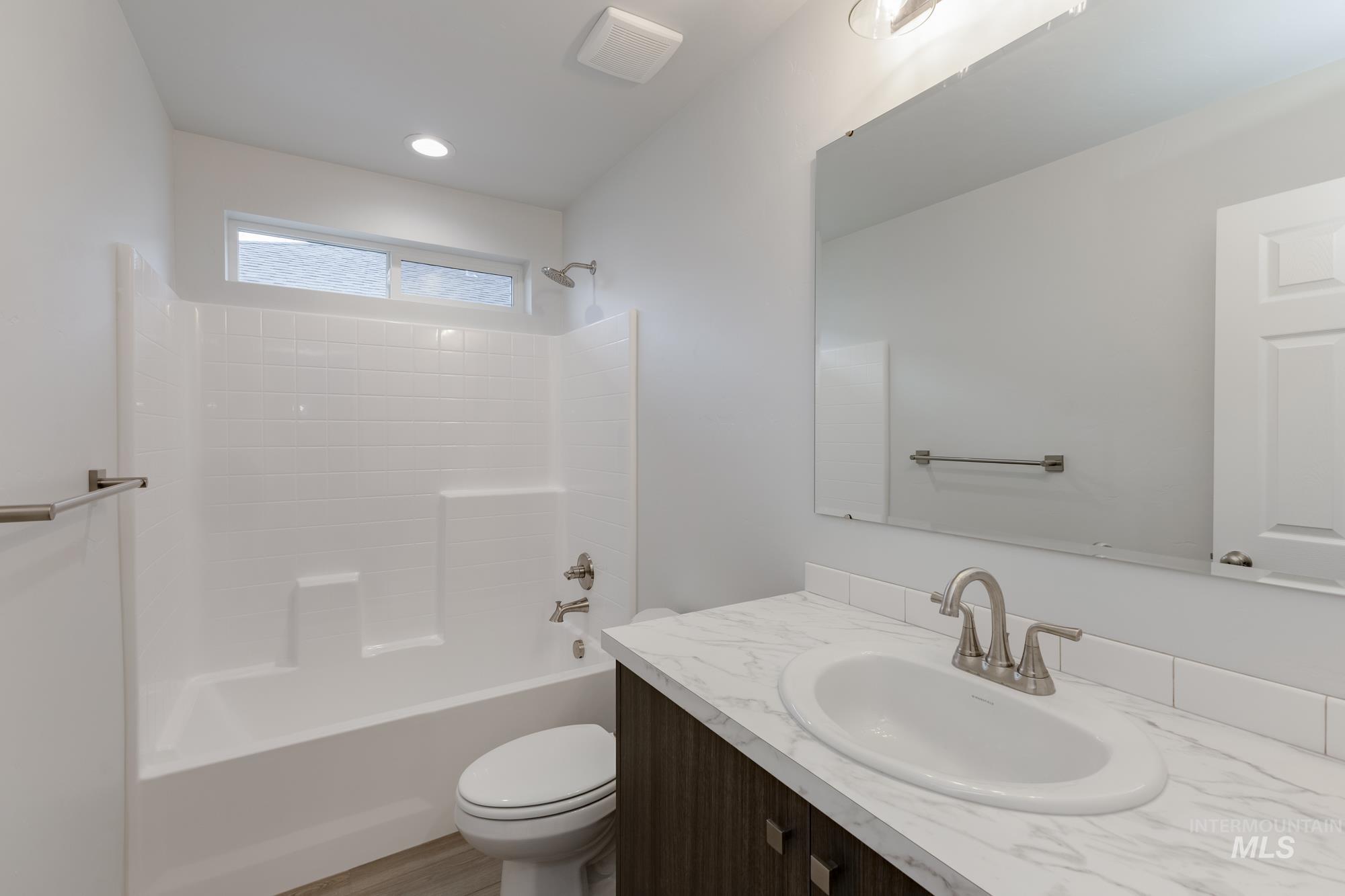 Bathroom featuring tub / shower combination and vanity