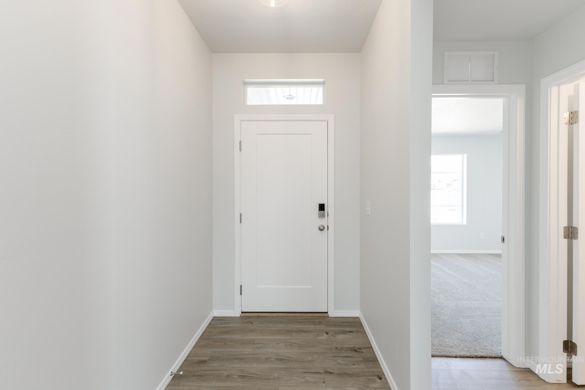 Doorway to outside featuring plenty of natural light and wood finished floors