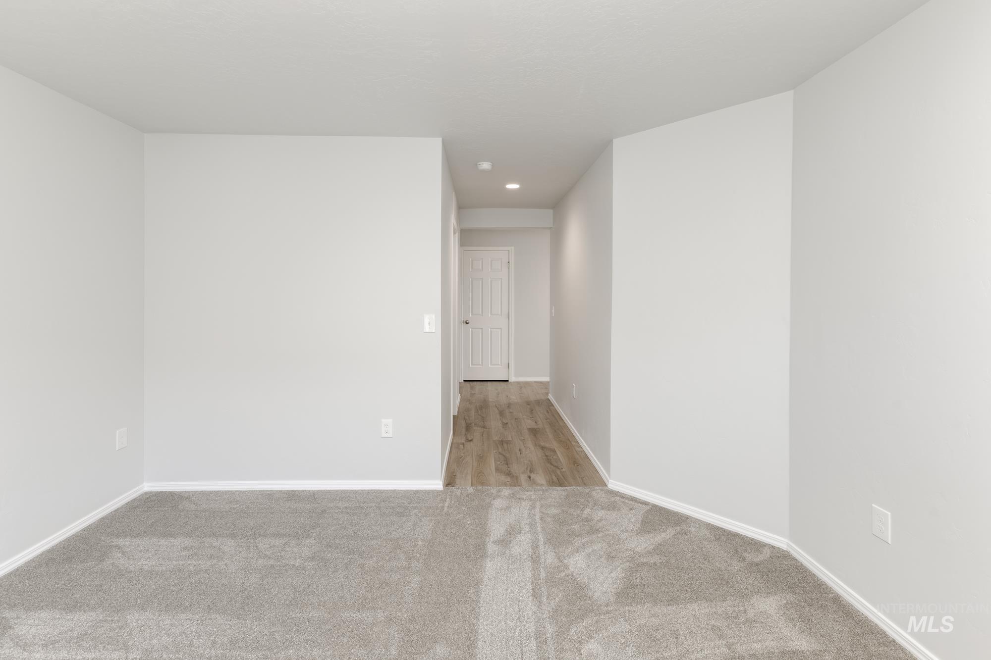 Unfurnished room with light colored carpet and recessed lighting