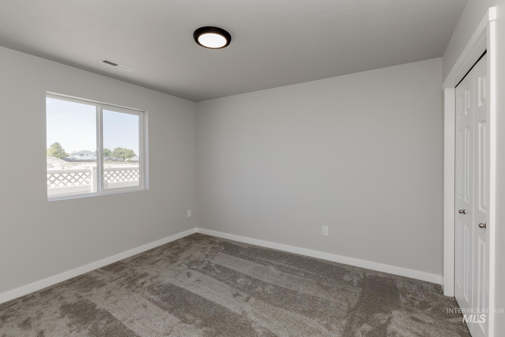 Unfurnished bedroom featuring carpet and a closet