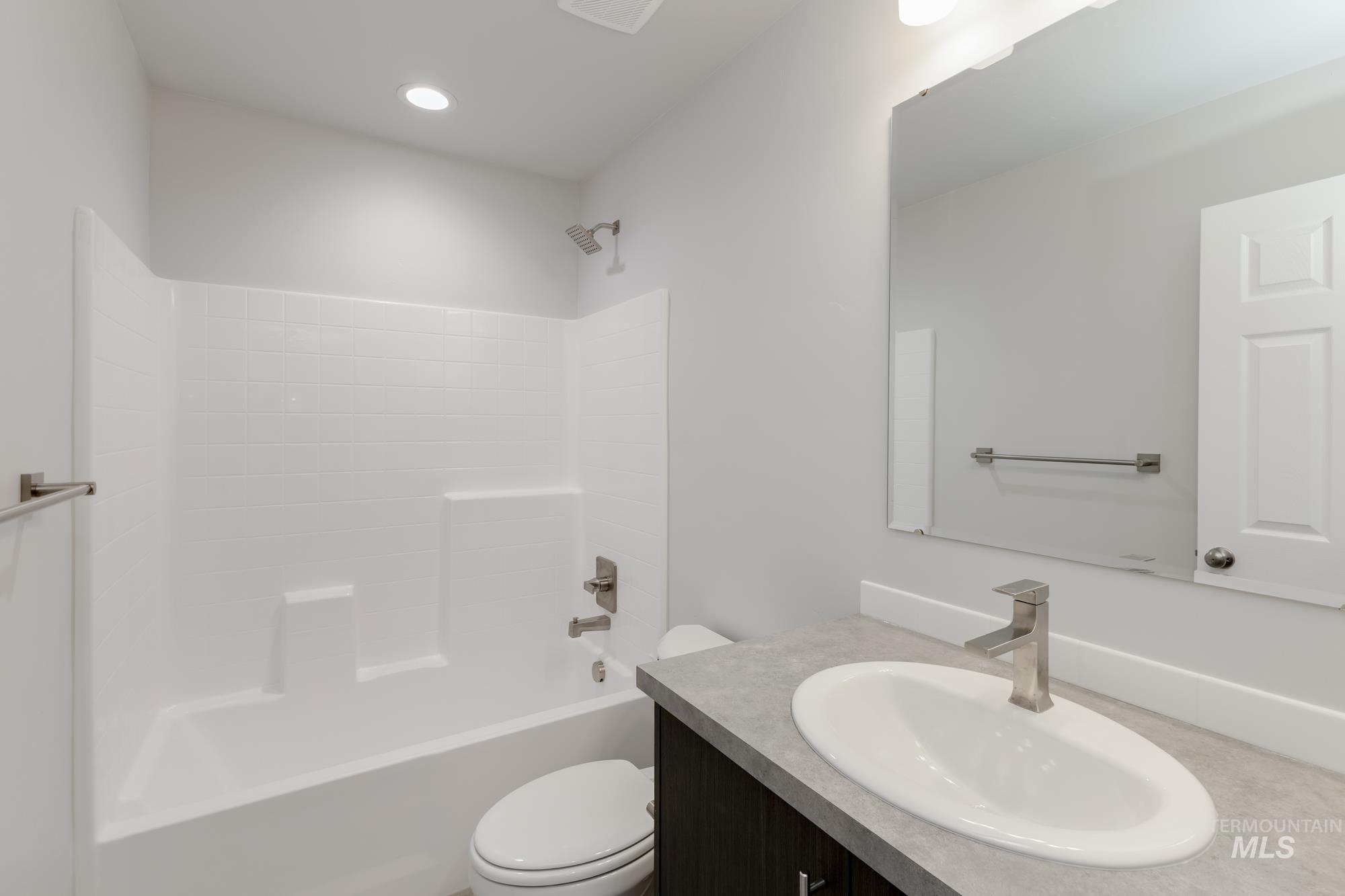 Full bathroom featuring washtub / shower combination, vanity, and recessed lighting