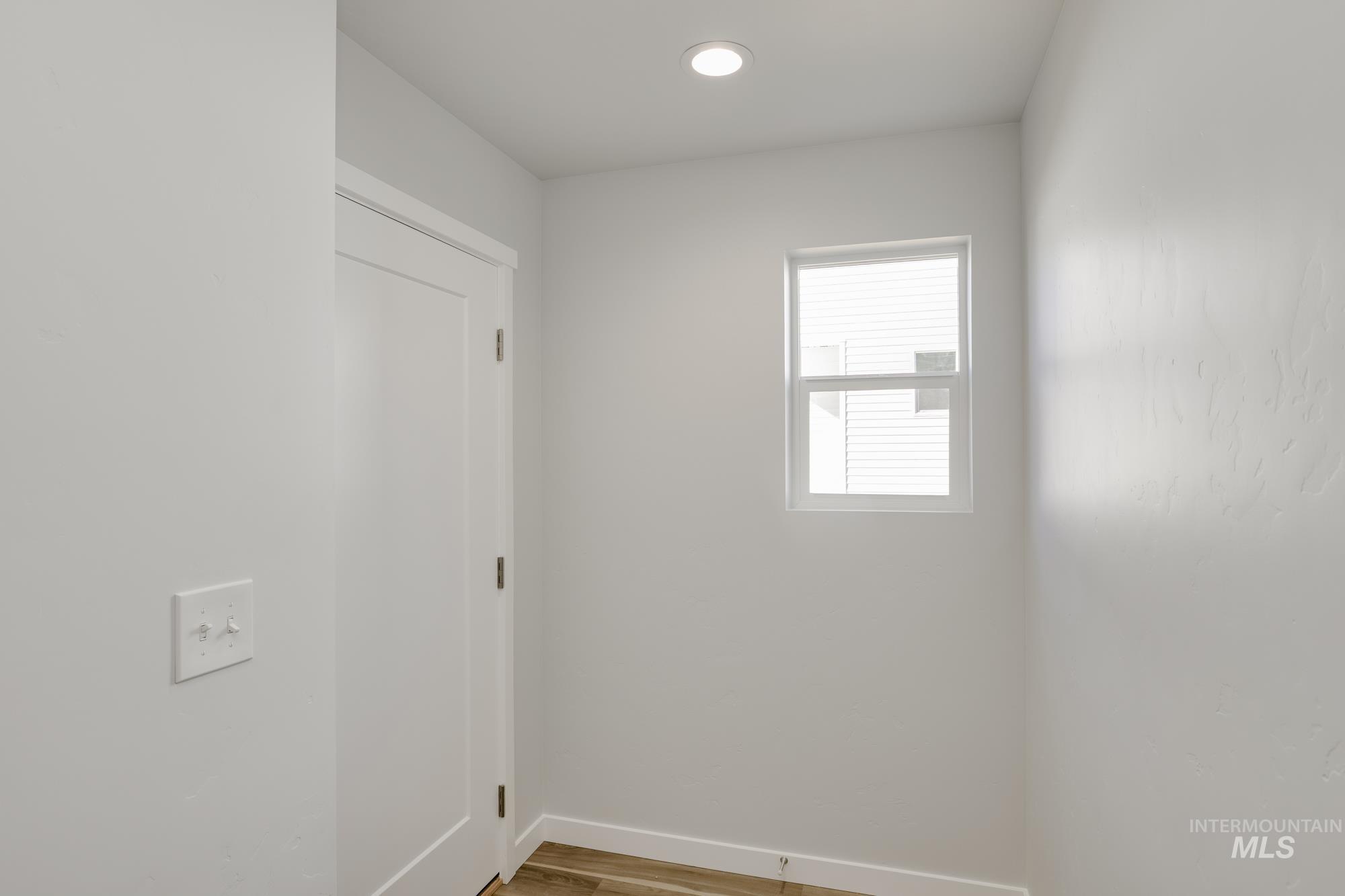 Unfurnished room with baseboards and light wood-style floors