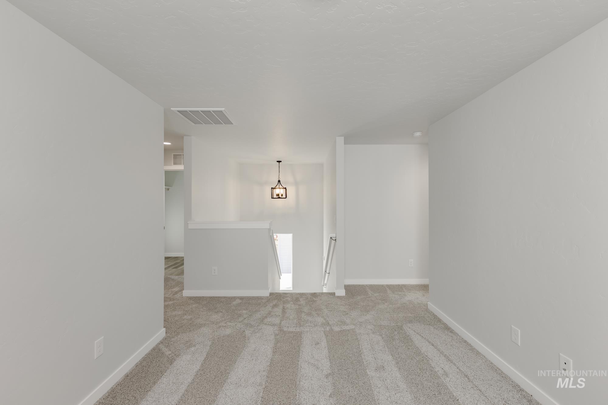 Carpeted empty room with baseboards