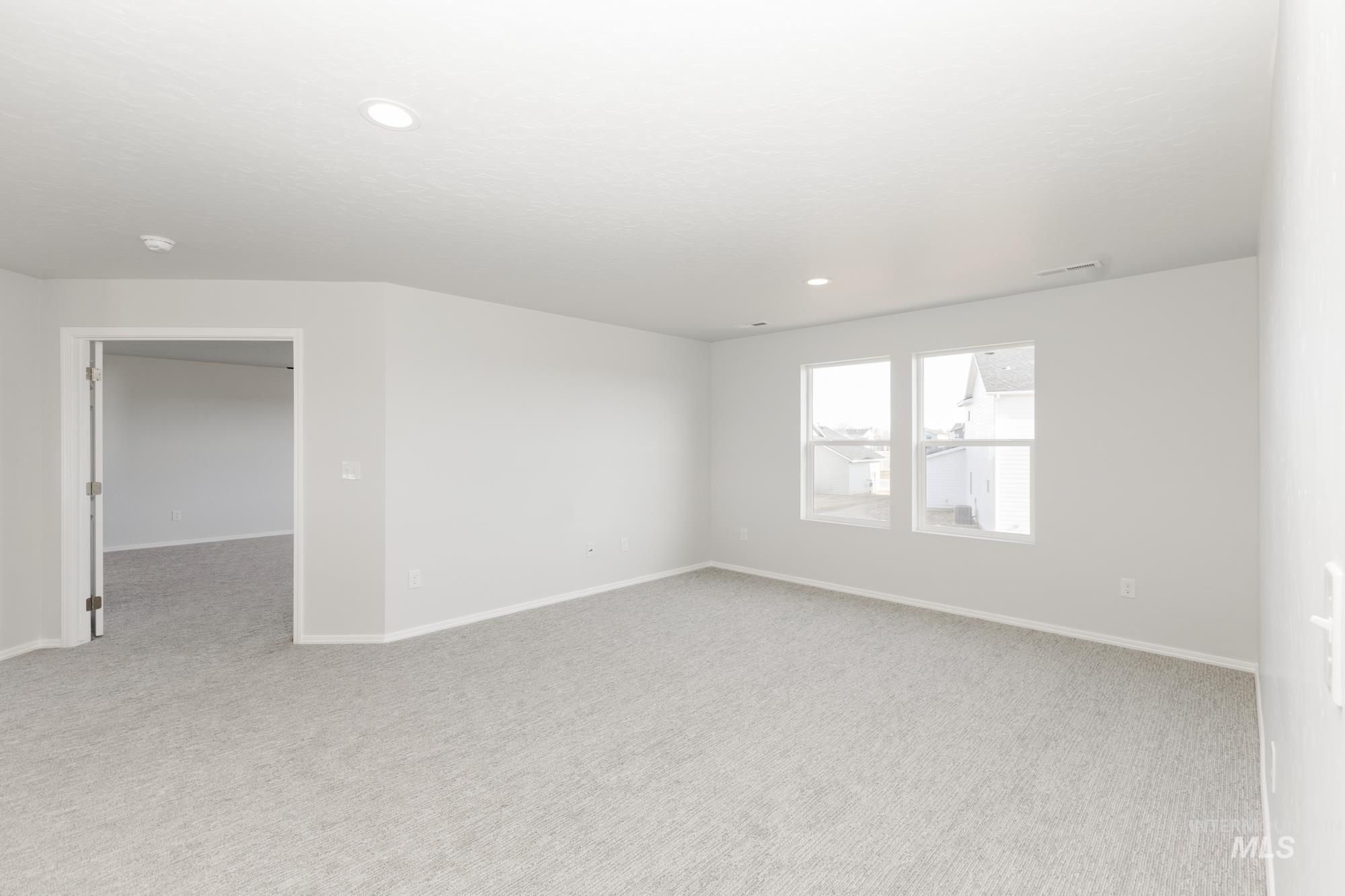 Unfurnished room featuring light carpet and recessed lighting