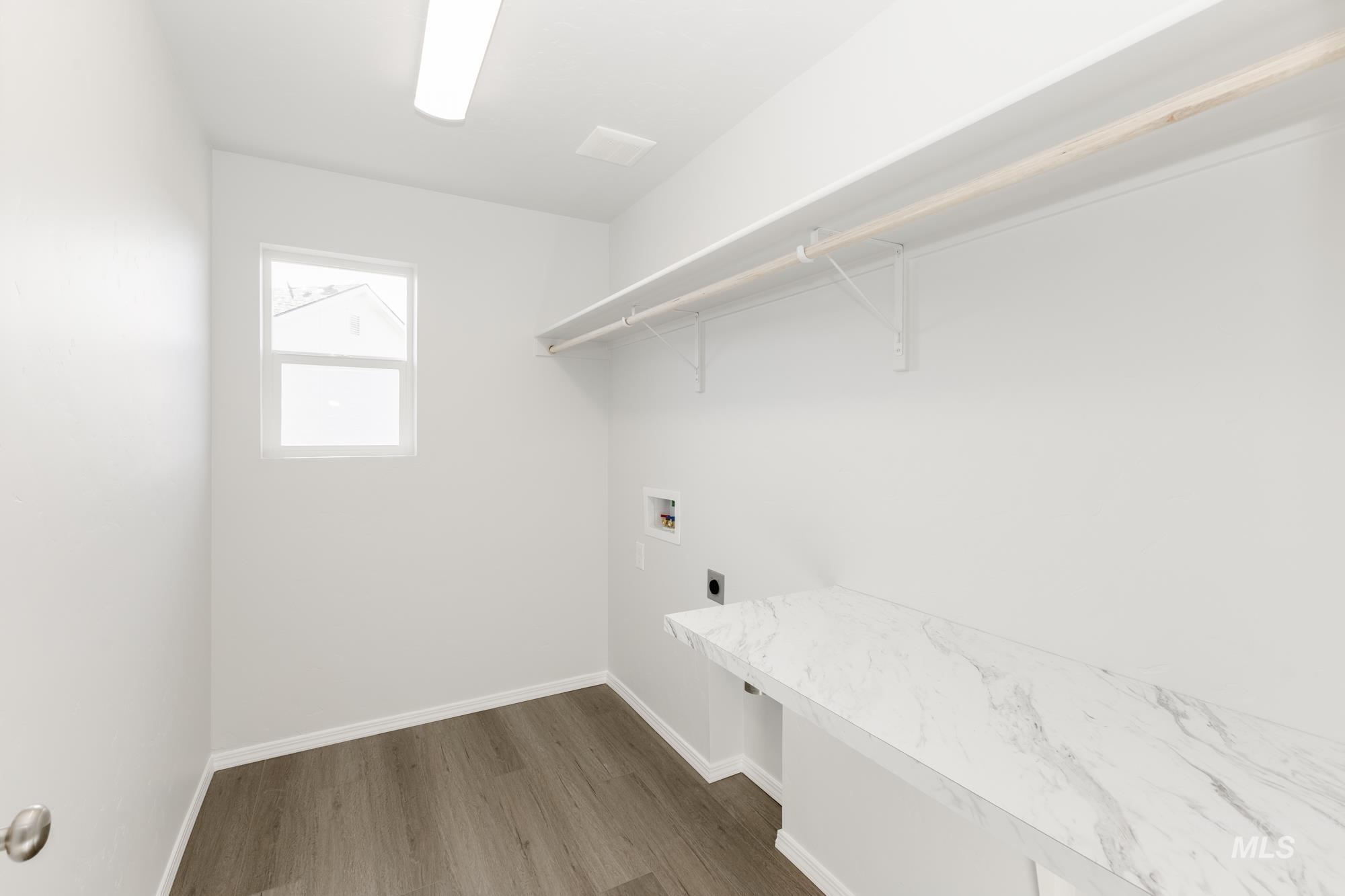 Laundry room featuring hookup for a washing machine, dark wood-style floors, and hookup for an electric dryer