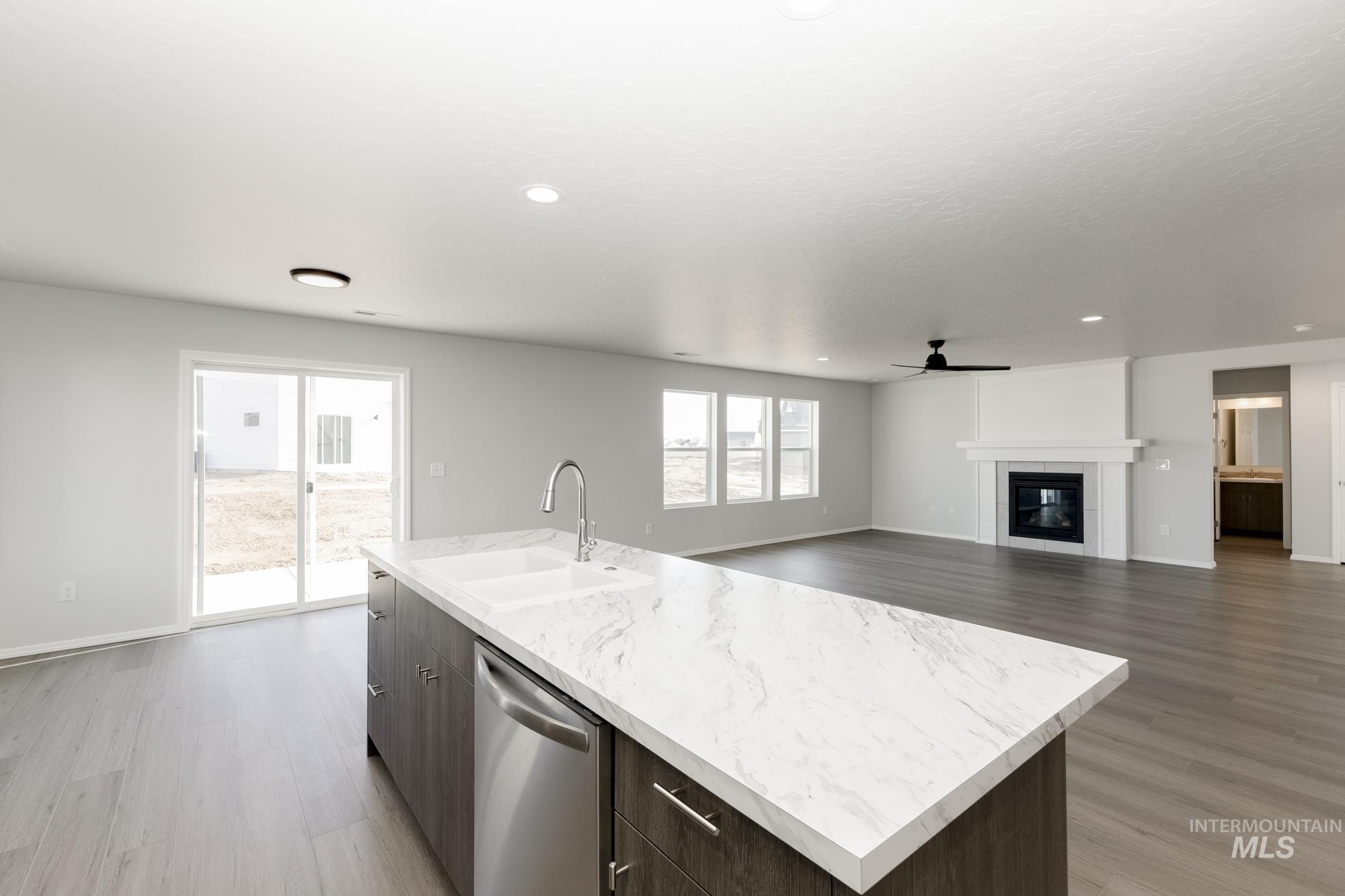 Kitchen with dark brown cabinetry, light wood finished floors, modern cabinets, and recessed lighting