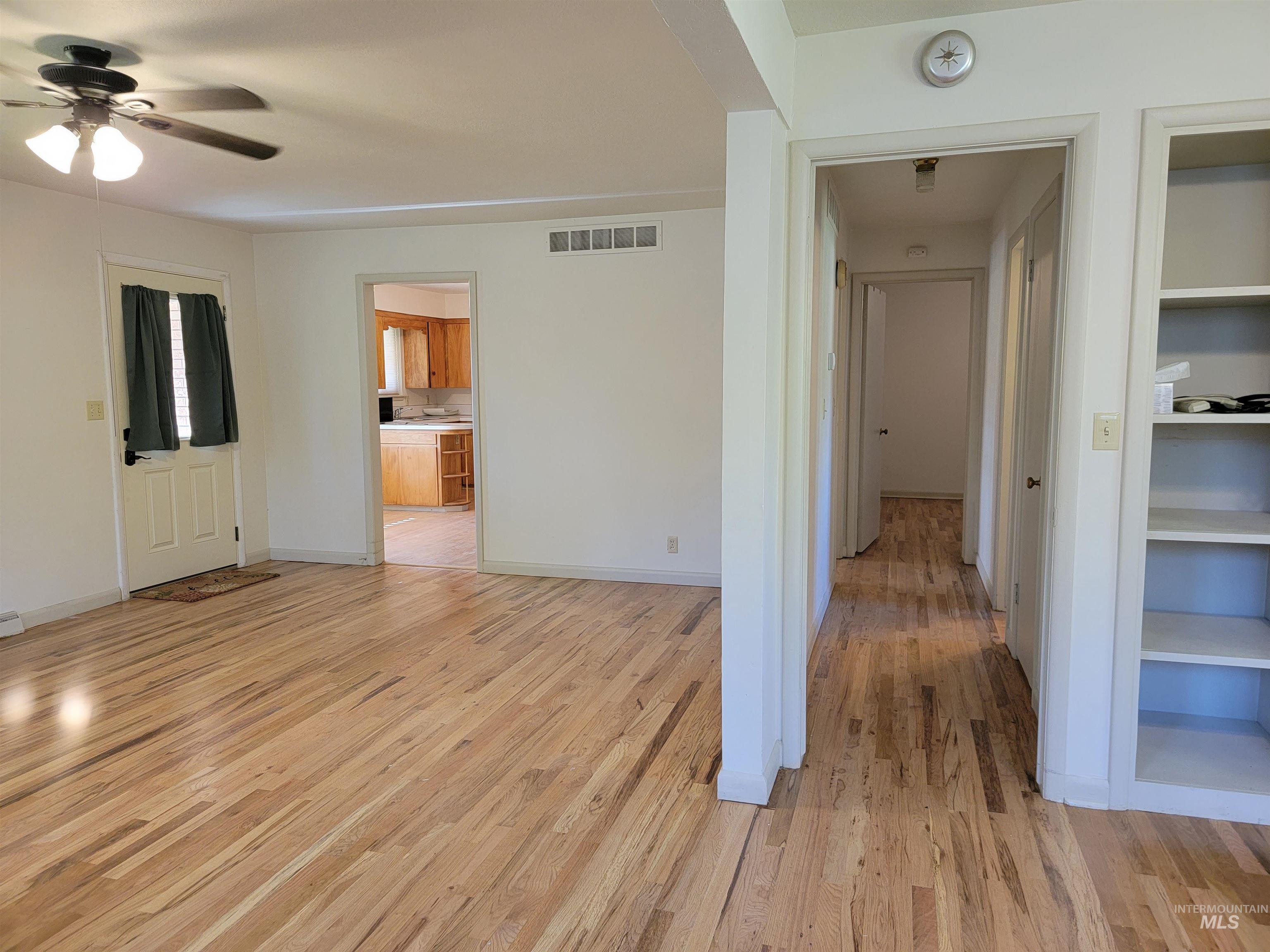 Hall with light wood finished floors and baseboards