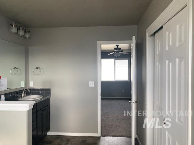 Bathroom featuring vanity and a ceiling fan