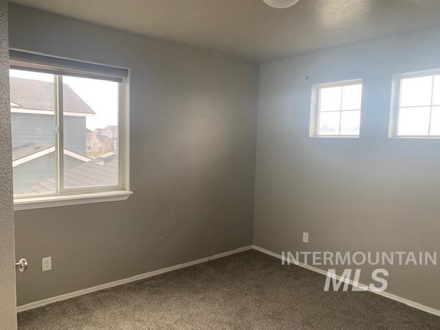 Unfurnished room with baseboards and carpet floors