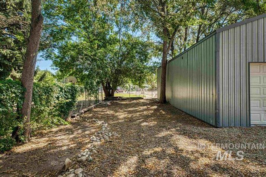View of yard featuring a garage and an outdoor structure