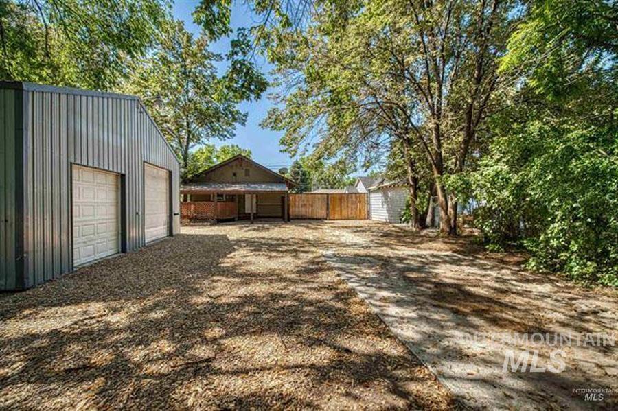 View of yard with an outdoor structure and a garage