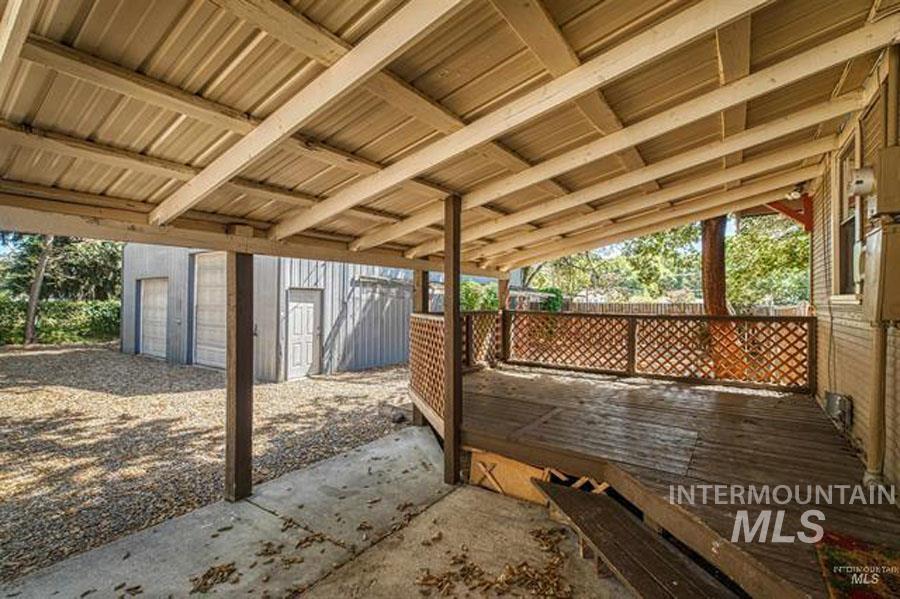 View of patio featuring an outbuilding and a wooden deck