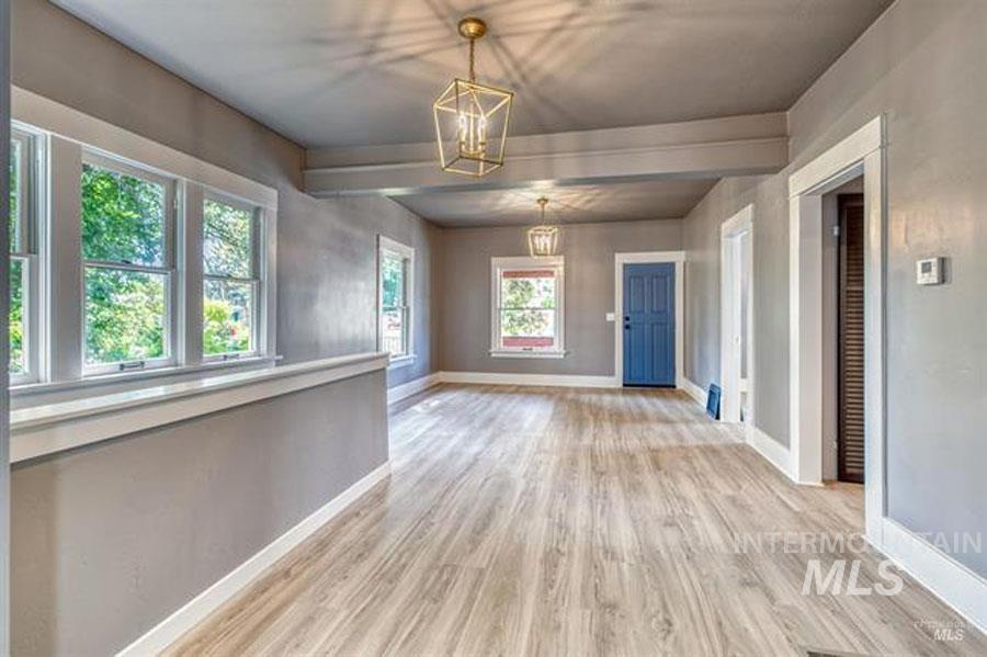 Entrance foyer featuring light wood-style floors and a chandelier