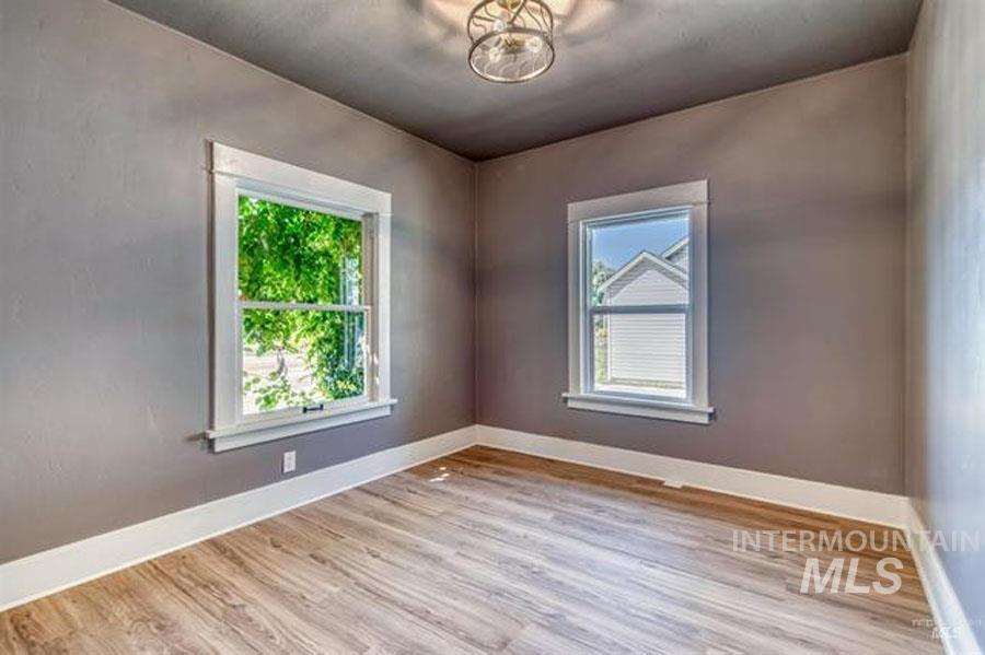 Unfurnished room featuring light wood-style floors and healthy amount of natural light