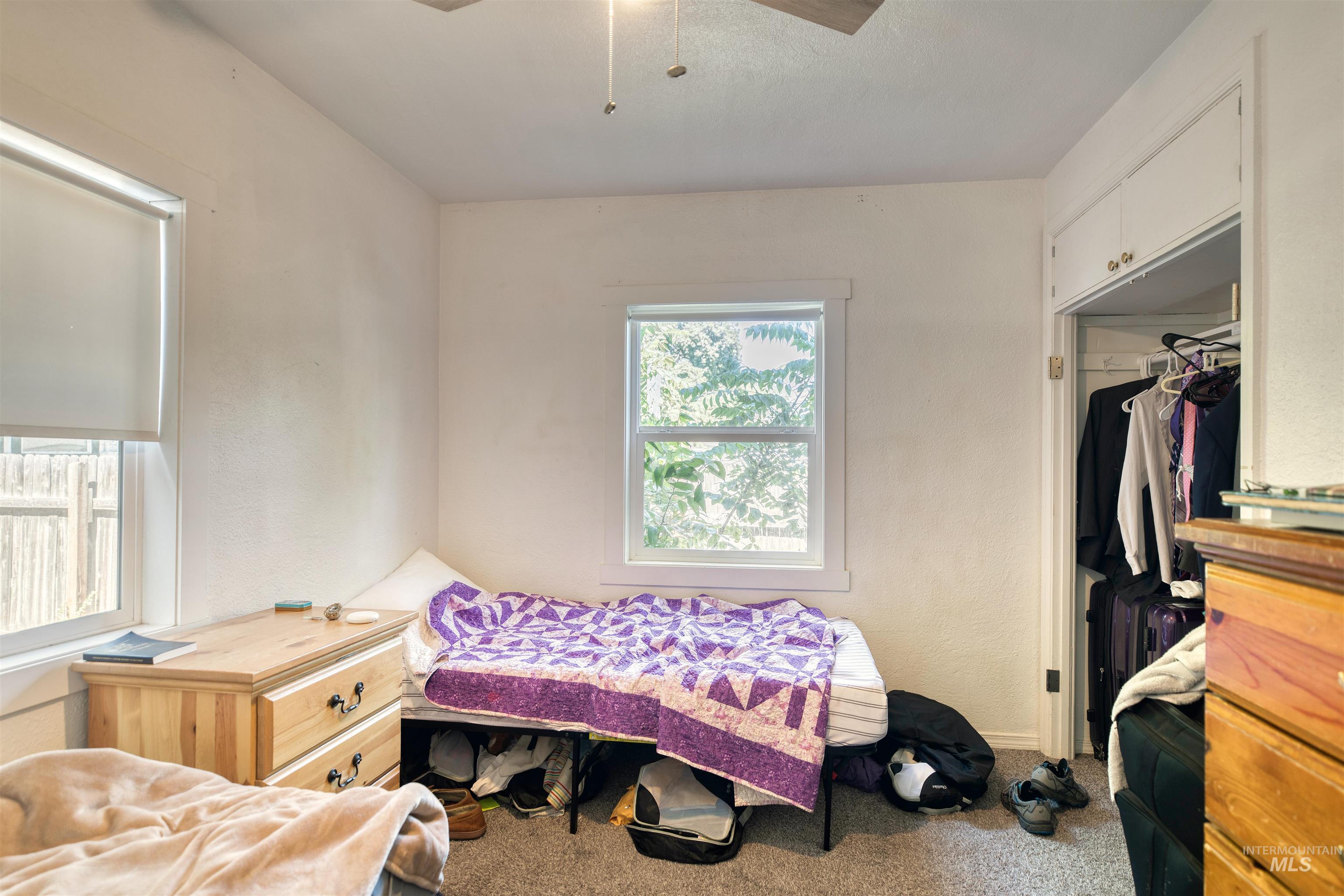 Bedroom featuring carpet and a closet
