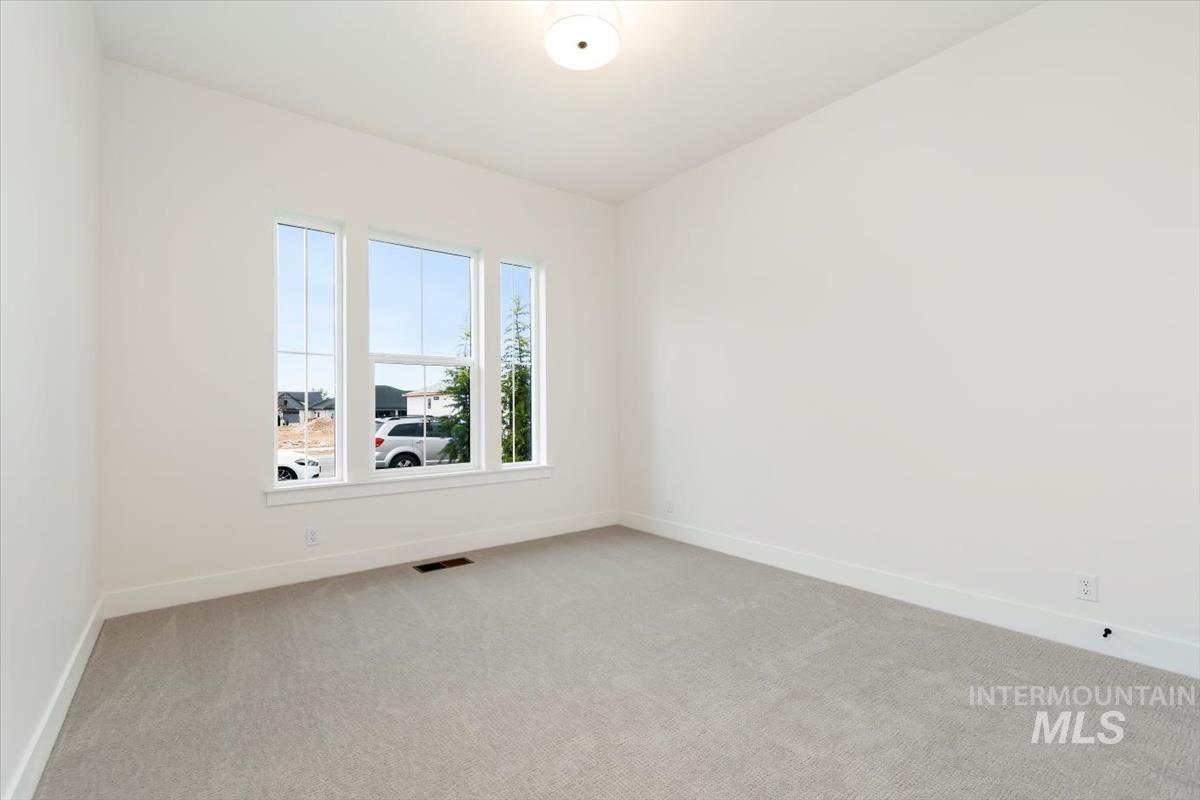 Unfurnished room featuring carpet floors and baseboards