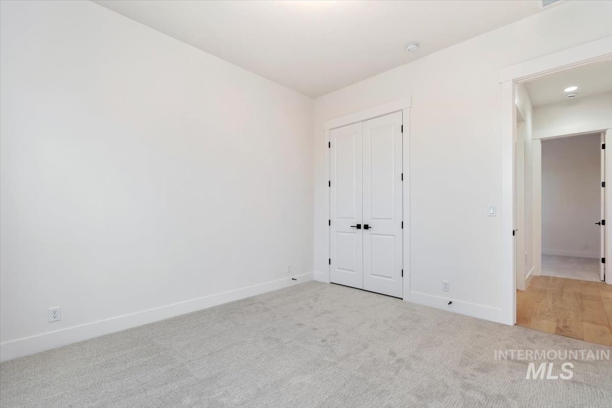Unfurnished bedroom with carpet flooring and a closet