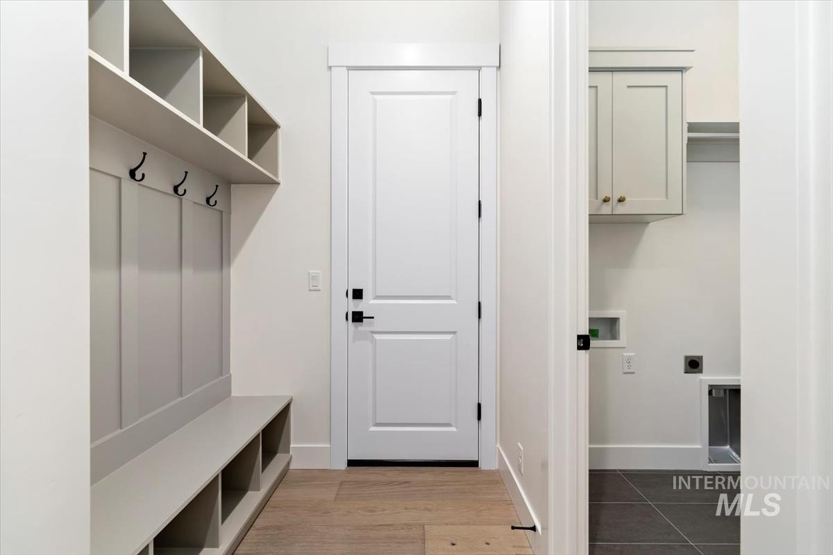 Mudroom with baseboards and wood finished floors