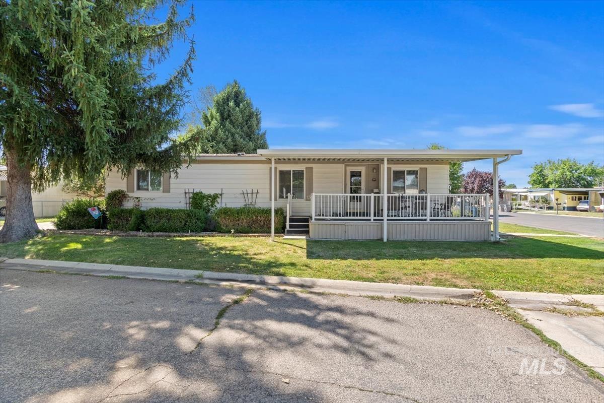 View of front of house with a front lawn and covered porch