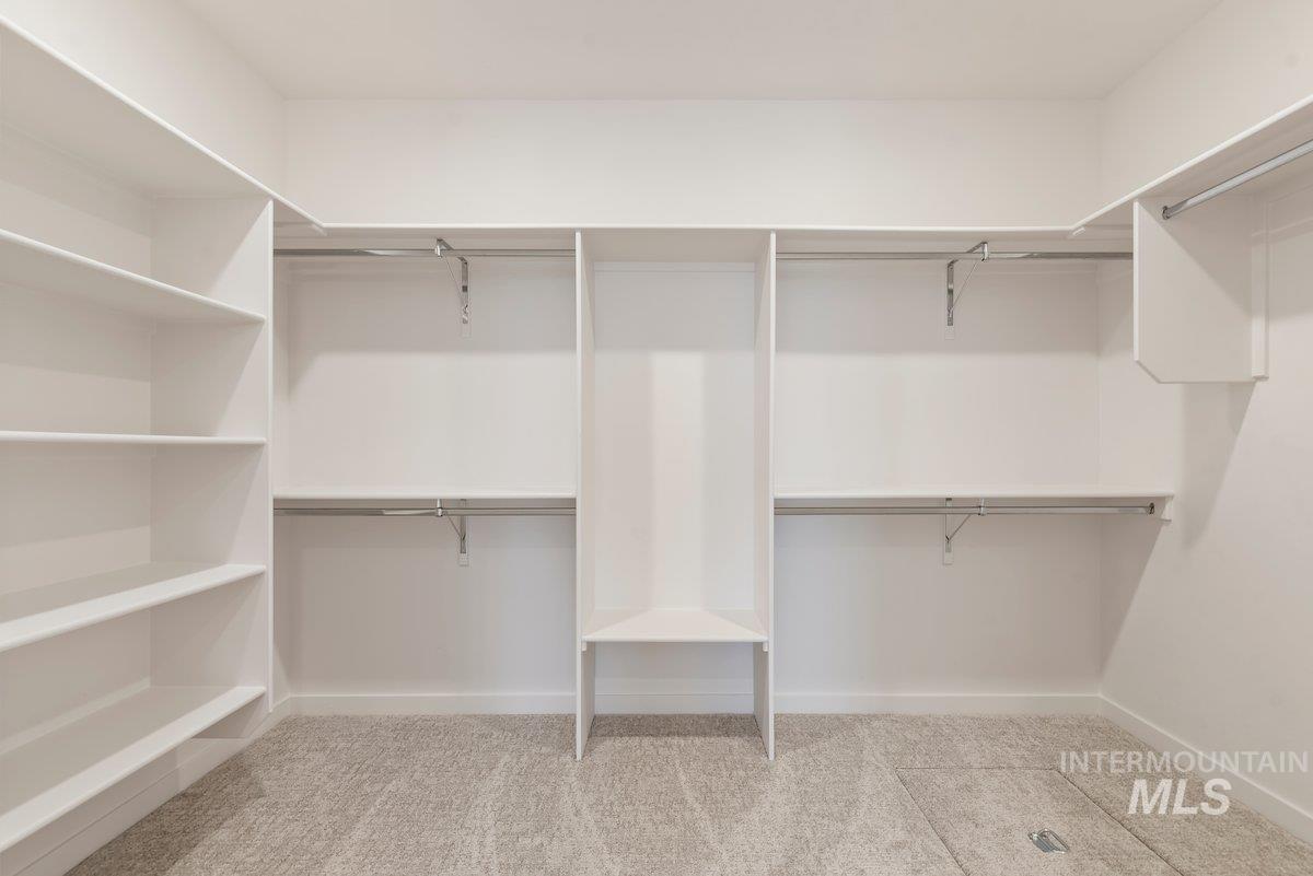 Spacious closet with light colored carpet