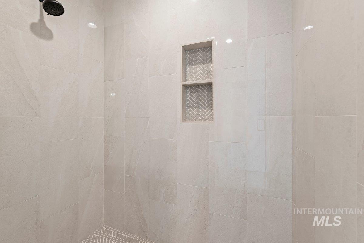 Bathroom view of a tile shower