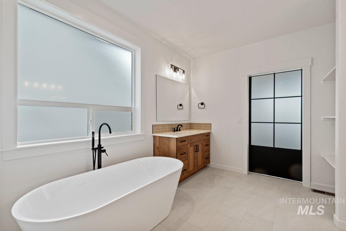 Bathroom featuring a freestanding bath and vanity
