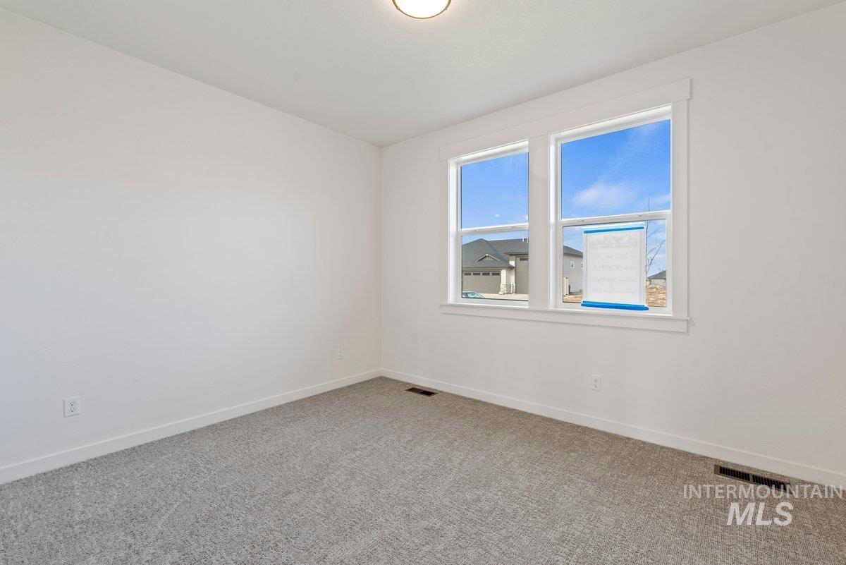 Spare room with carpet flooring and baseboards