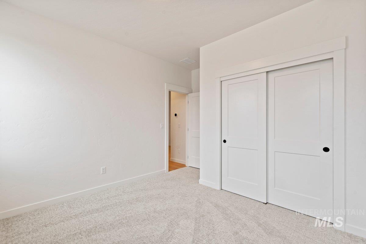 Unfurnished bedroom featuring carpet and a closet