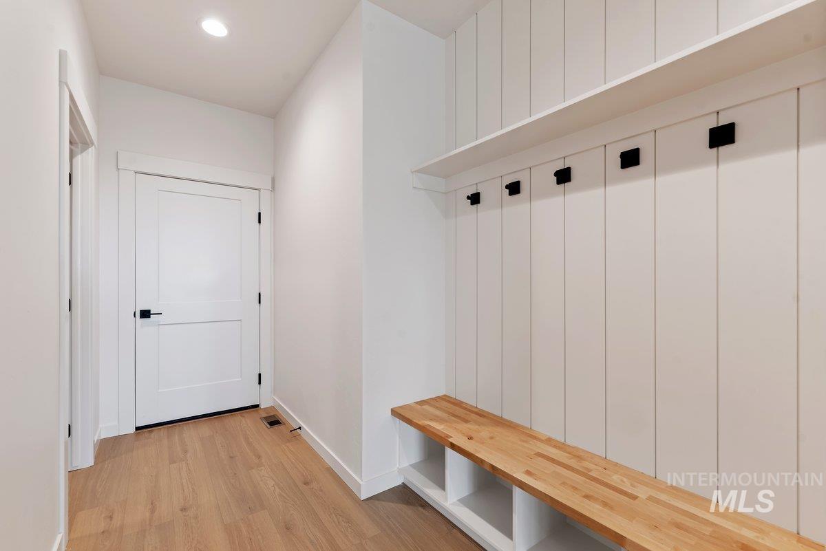 Mudroom featuring light wood finished floors and recessed lighting