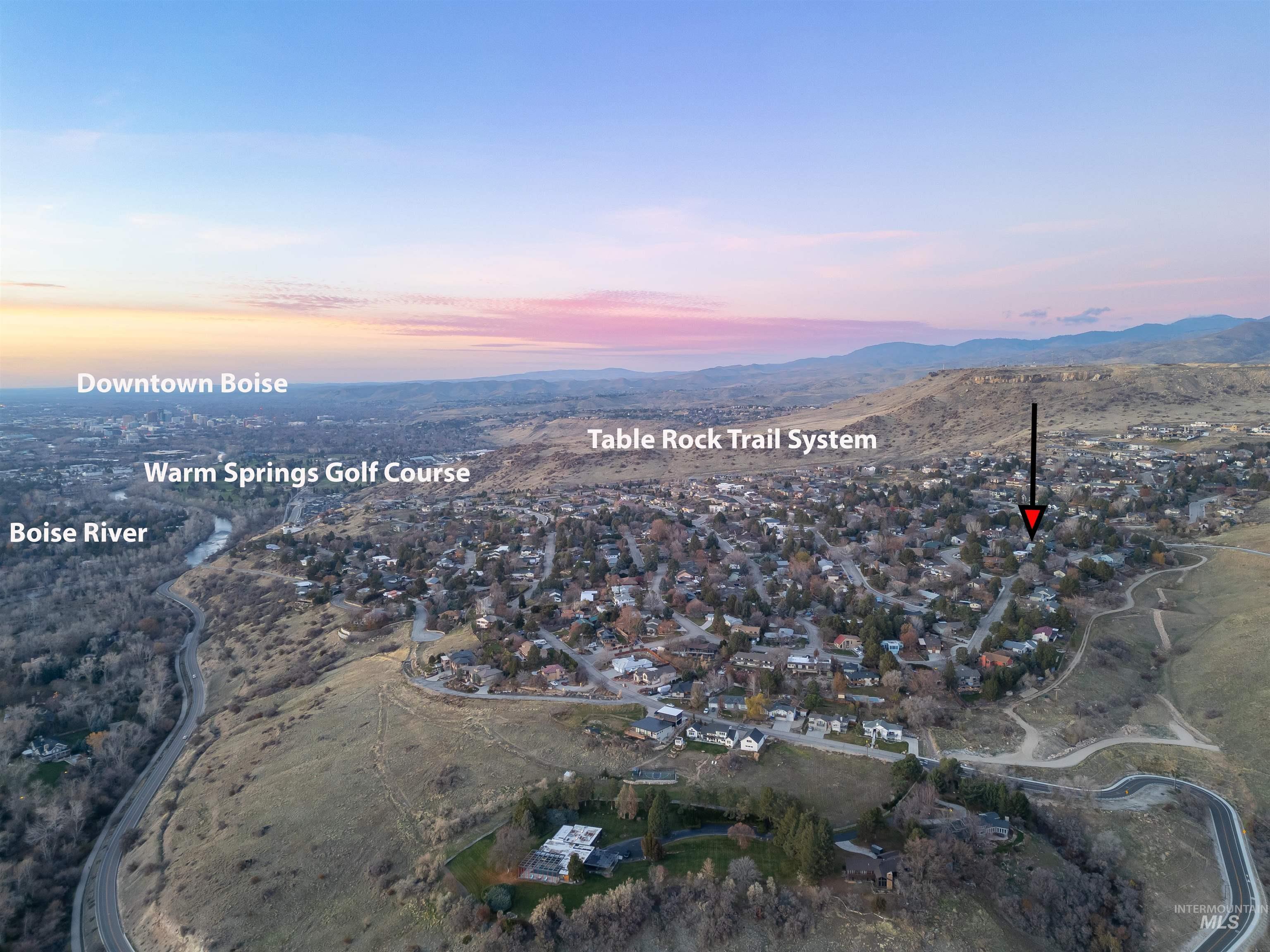 Aerial view of property and surrounding area featuring mountains