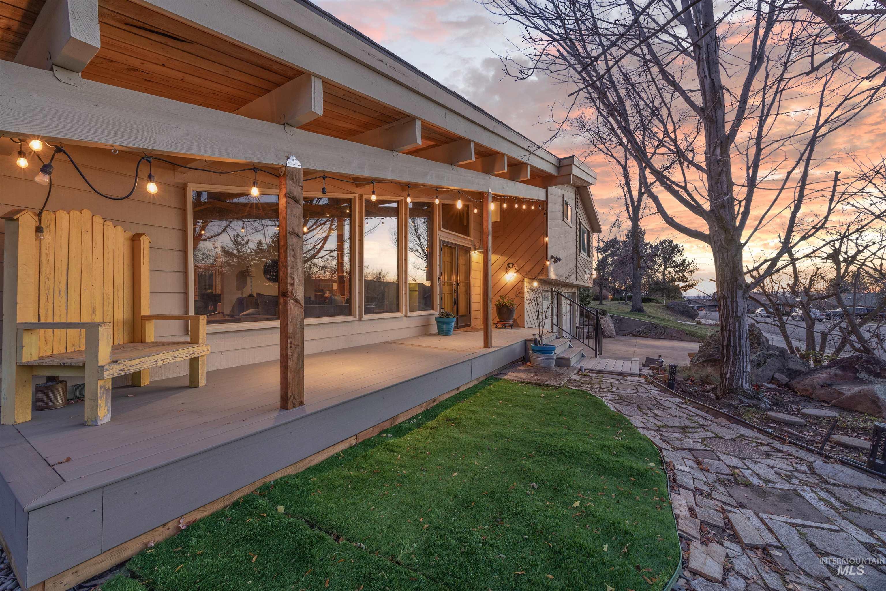 Back of property with a lawn