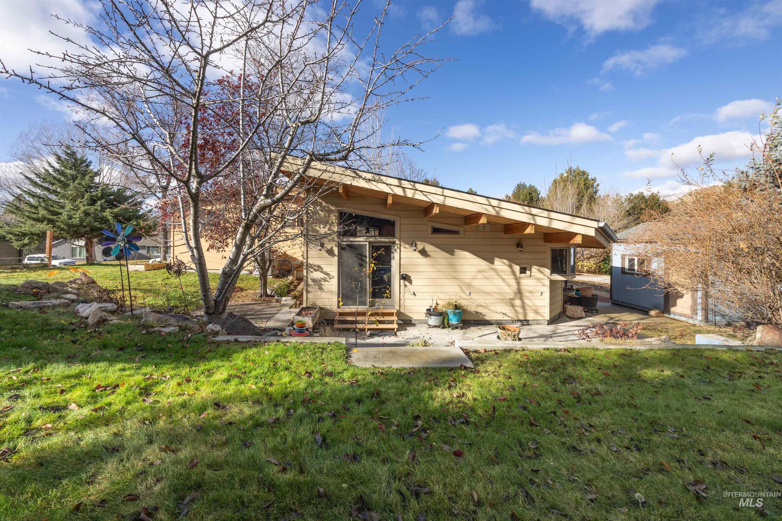 Back of house featuring a yard, a patio, and entry steps
