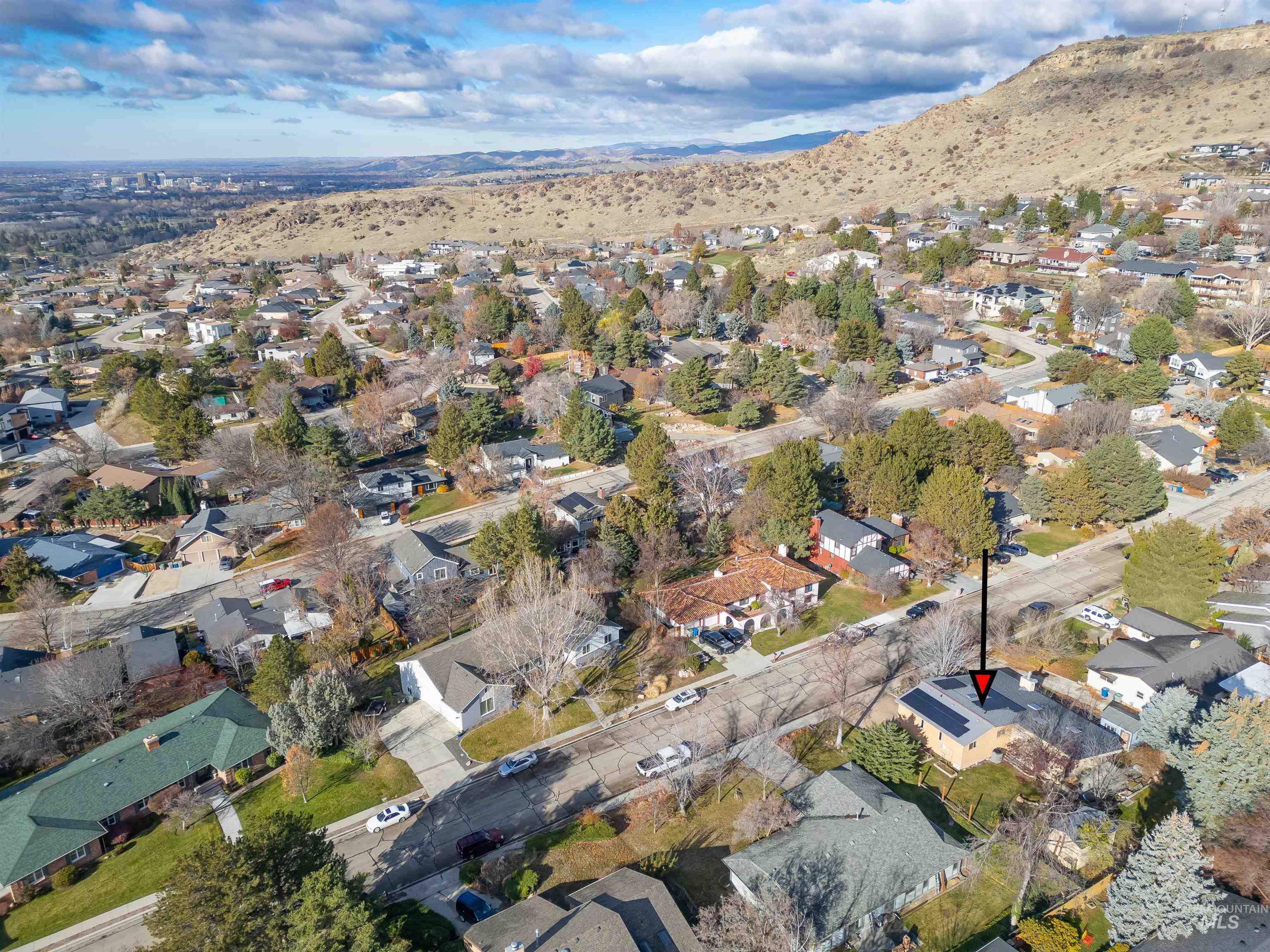 Aerial overview of property's location featuring nearby suburban area and mountains