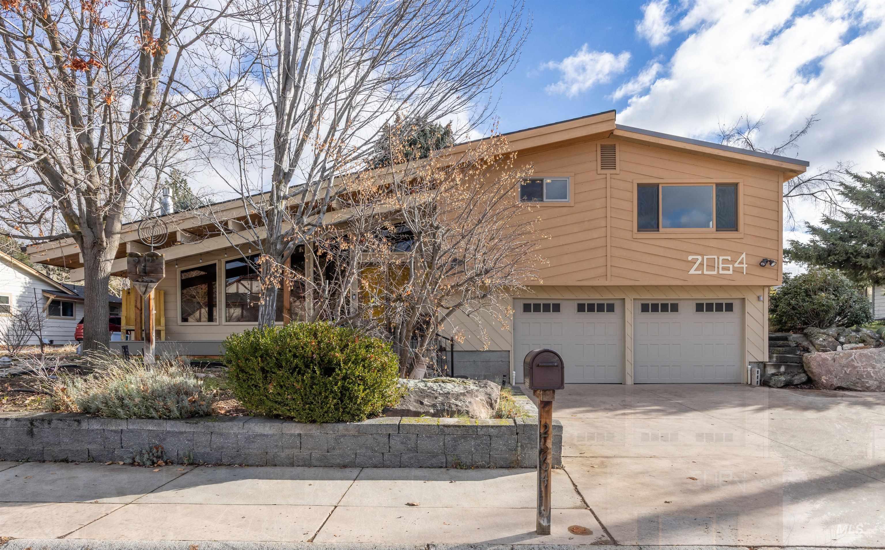 View of front of property with driveway and a garage