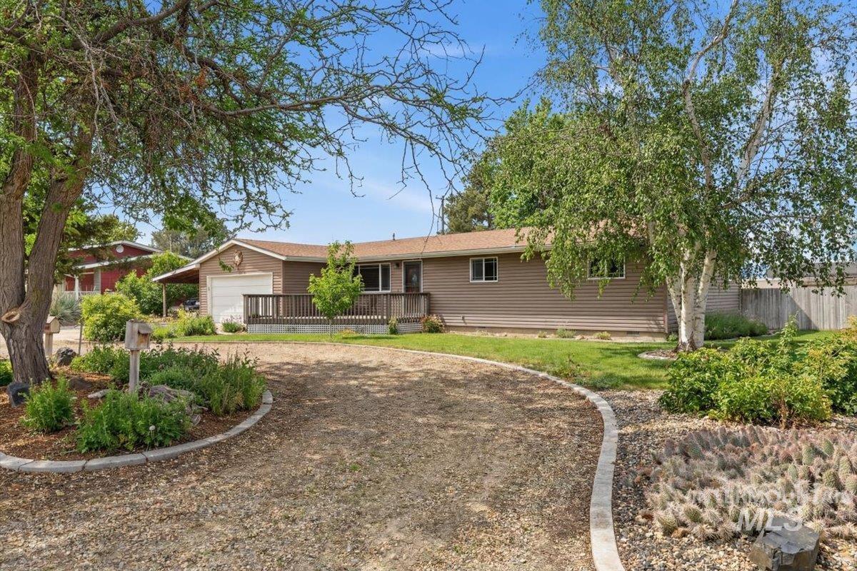 Single story home with driveway and a garage