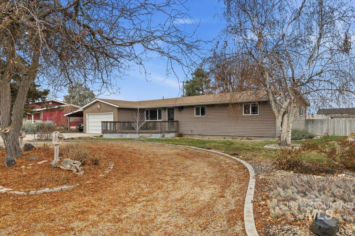 Single story home with driveway and a garage
