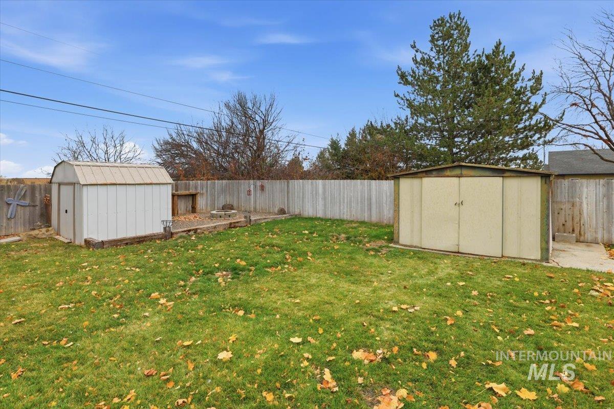 Fenced backyard with a storage shed