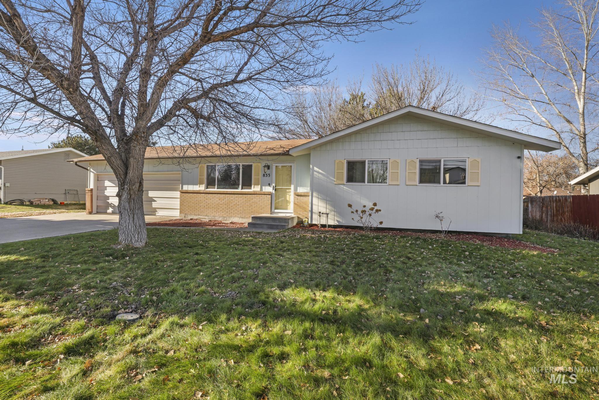View of front of property with brick siding, driveway, an attached garage, and entry steps