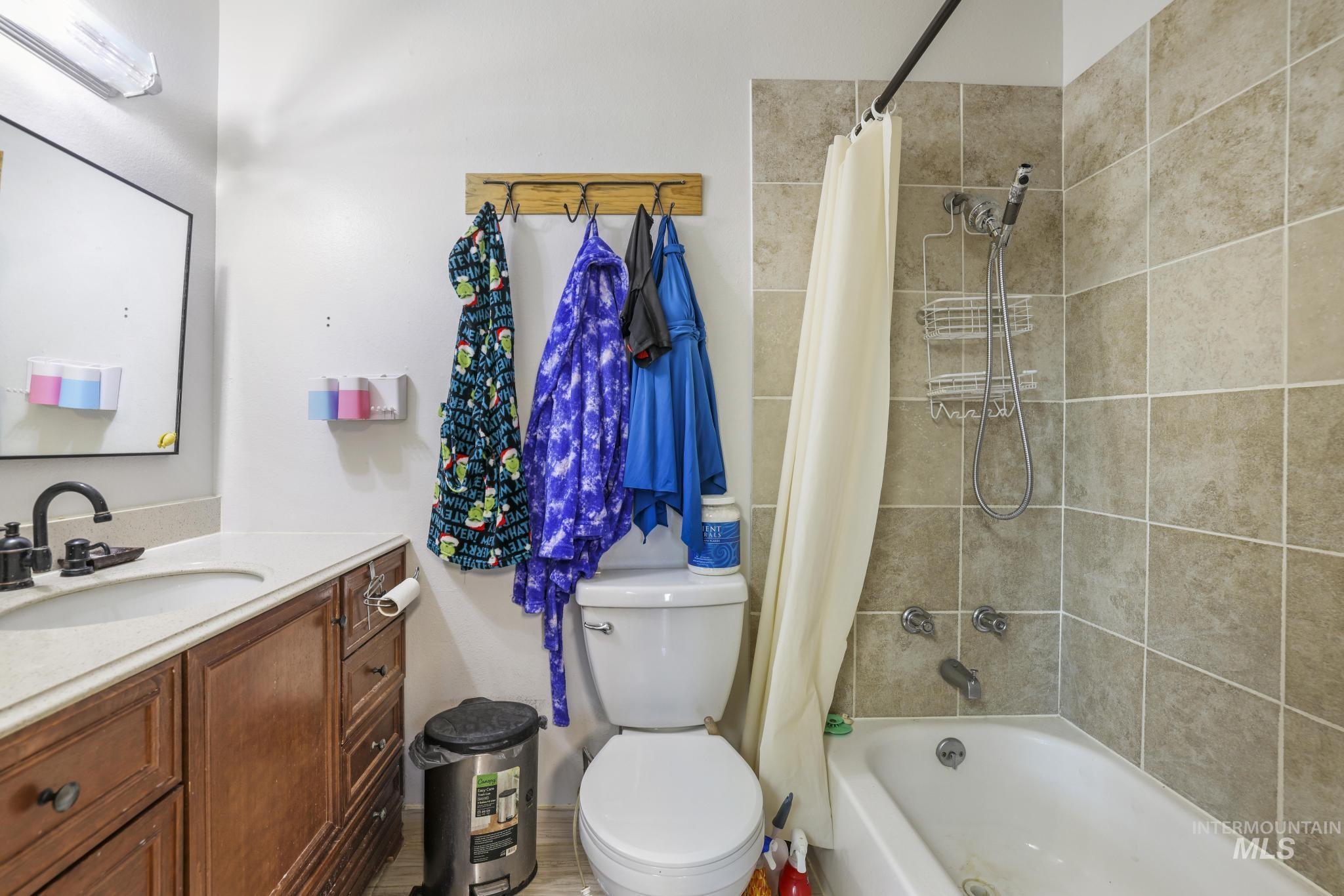 Bathroom featuring vanity and shower / tub combo with curtain