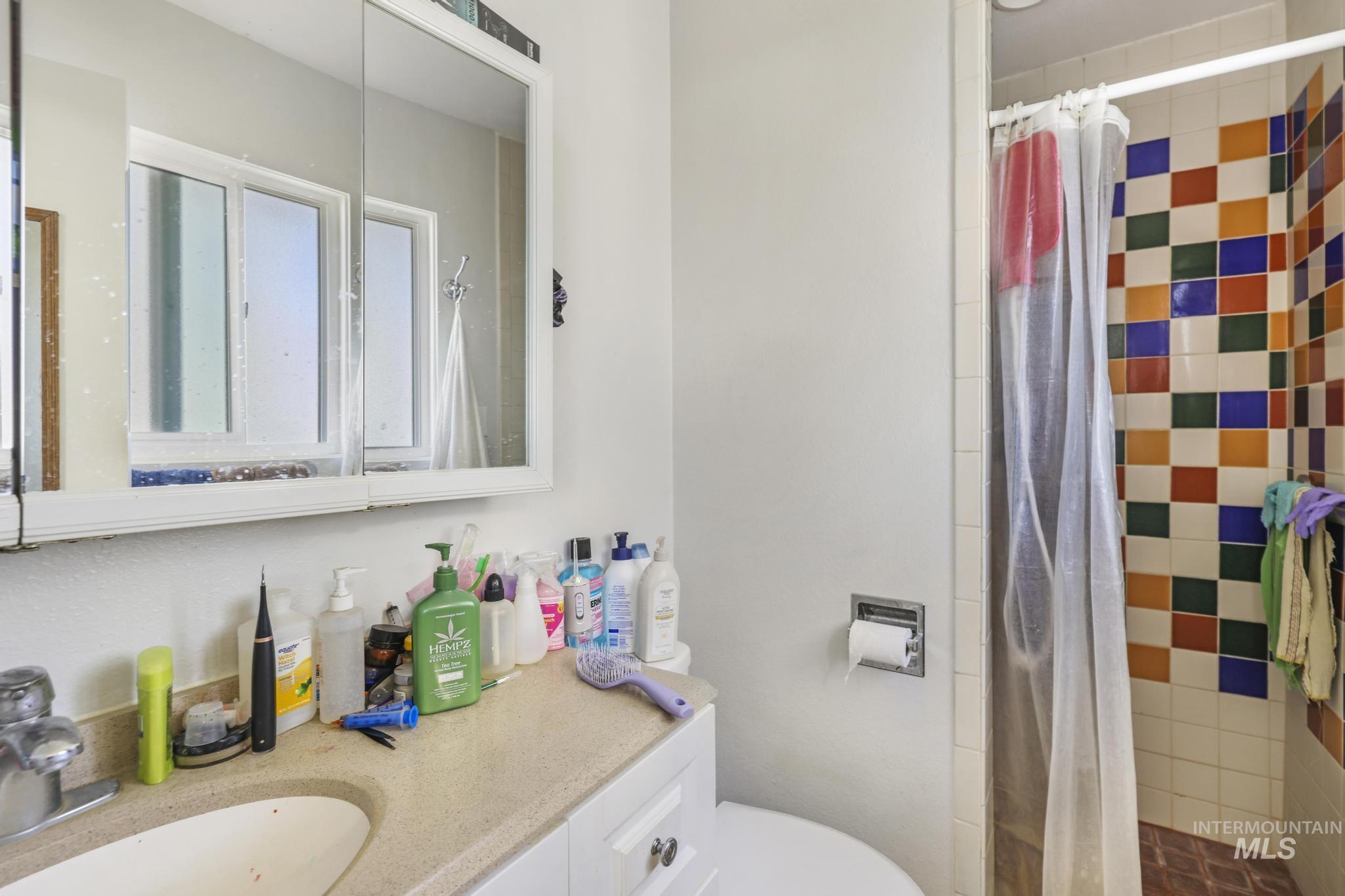 Full bath with a stall shower and vanity