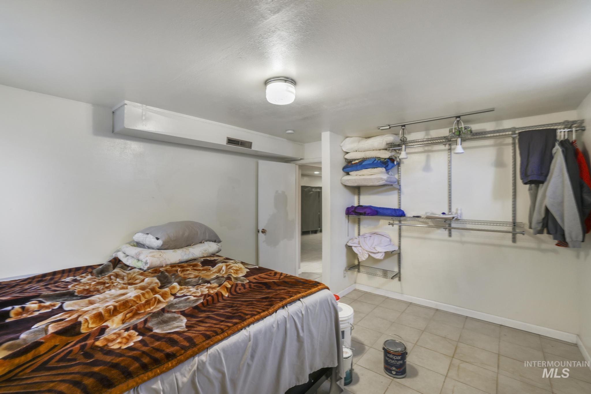 Bedroom featuring baseboards and light tile patterned floors