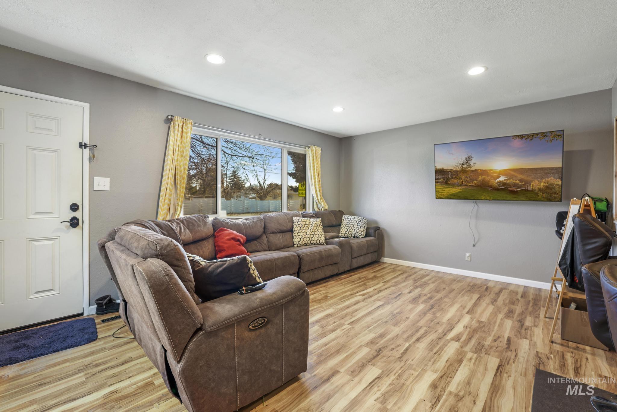 Living room featuring light wood-type flooring and recessed lighting