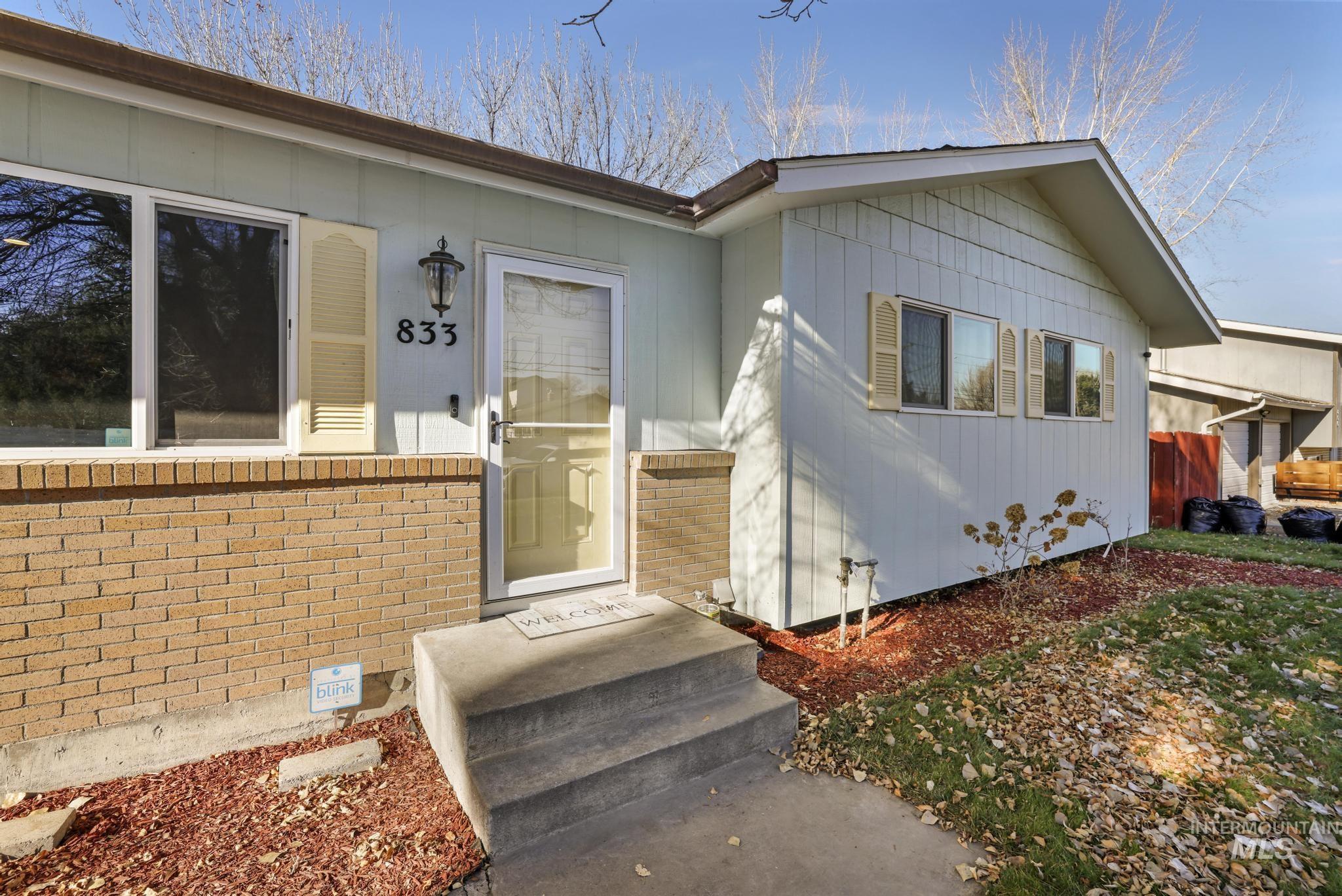 Entrance to property featuring brick siding and crawl space