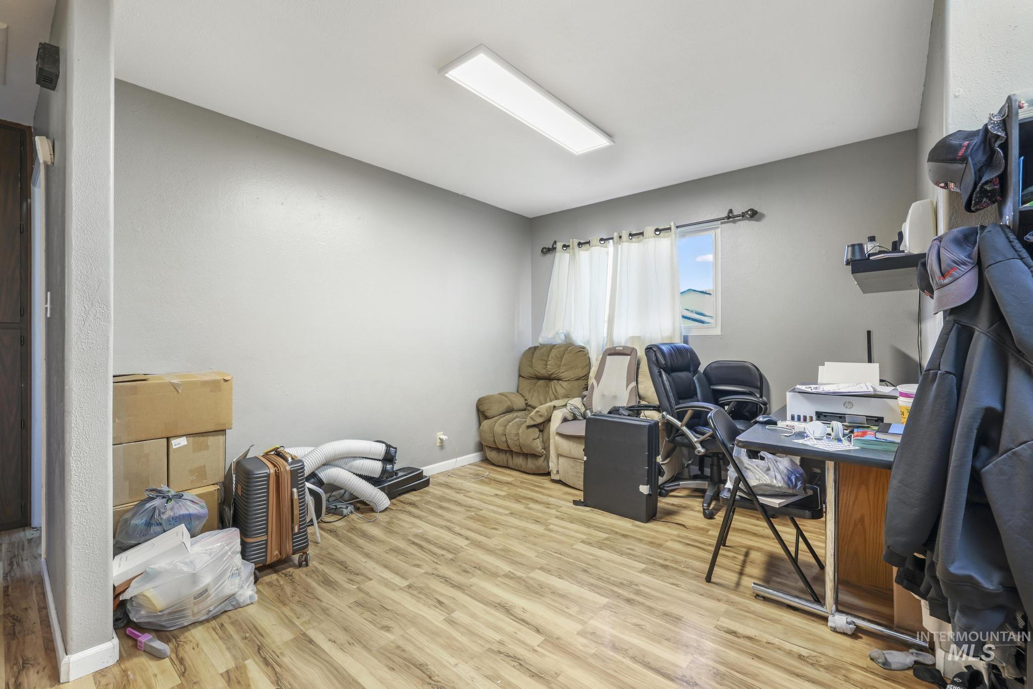 Office with light wood finished floors and baseboards