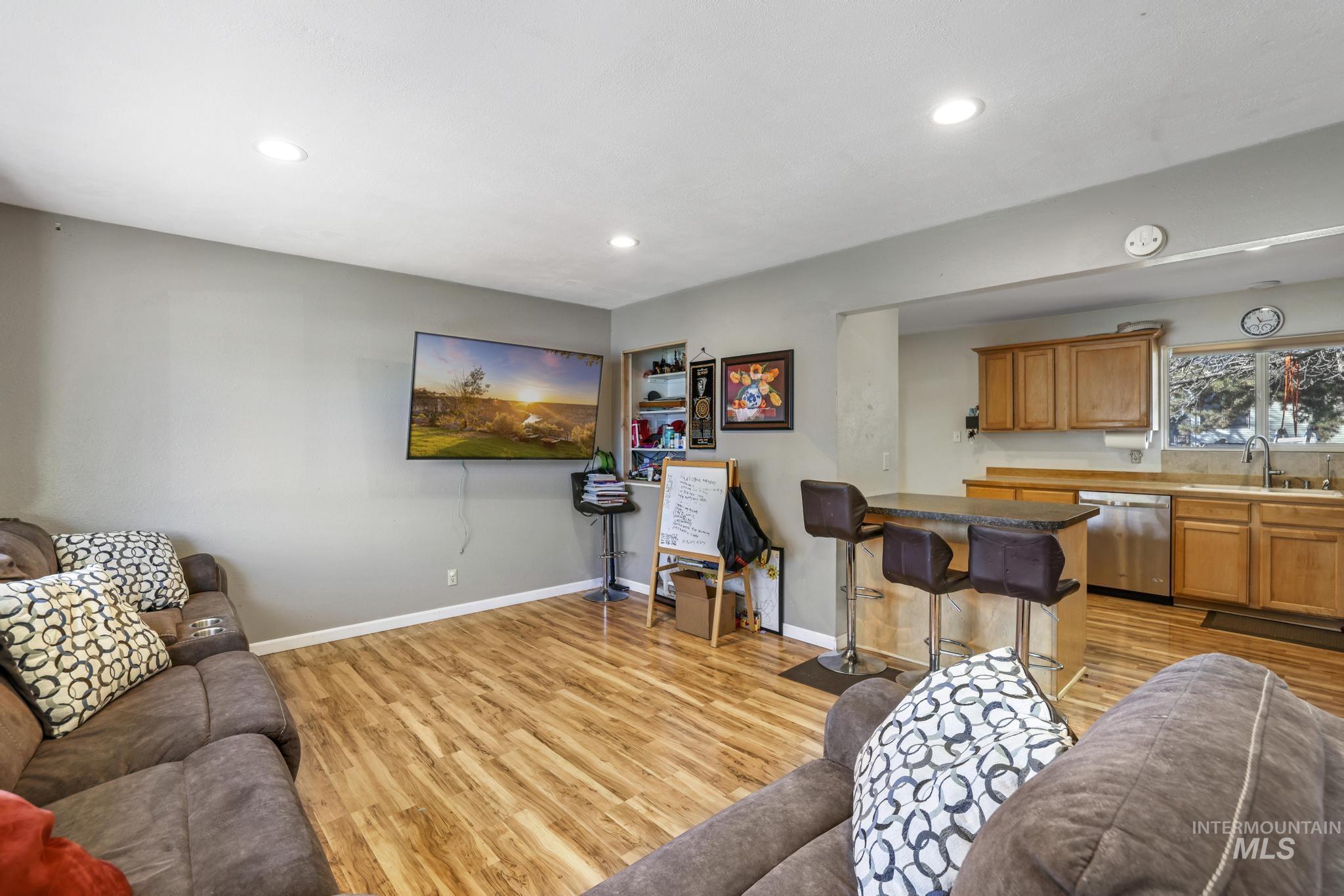 Living room featuring light wood-style flooring and recessed lighting