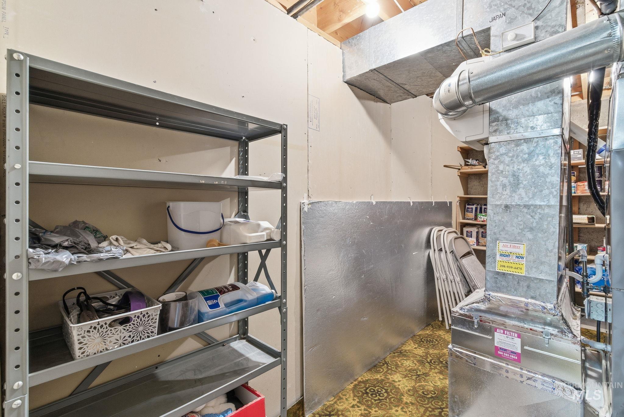 Utility room featuring heating unit