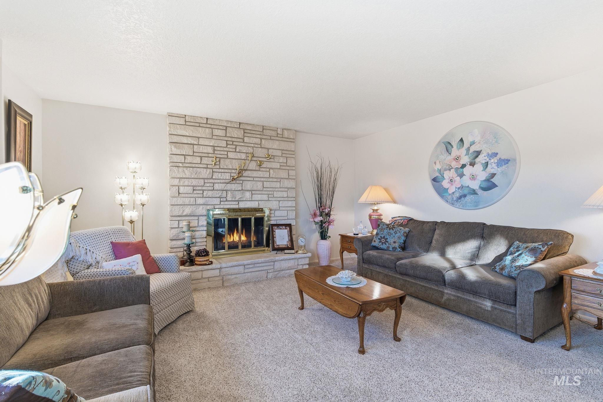 Living room featuring a fireplace and carpet floors
