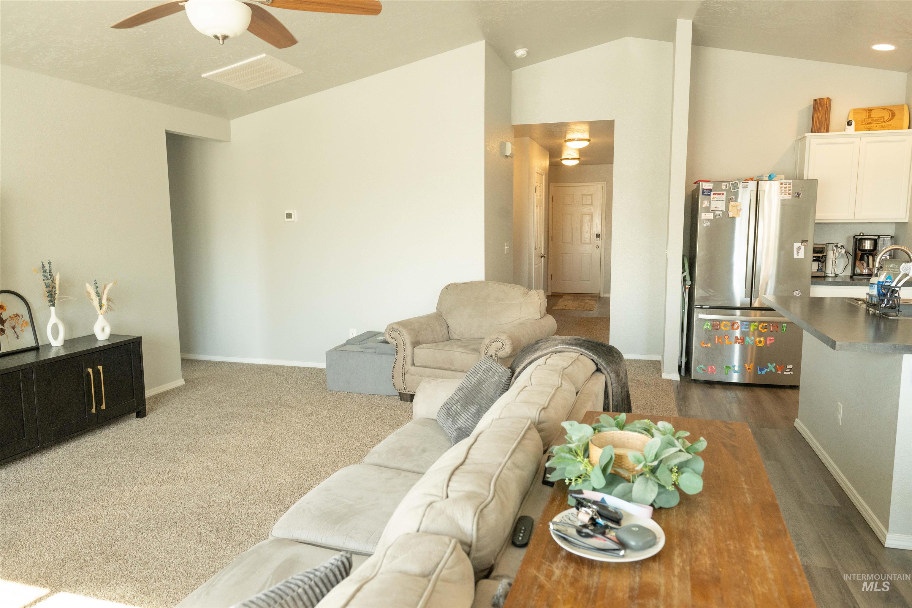 Living area featuring lofted ceiling and ceiling fan